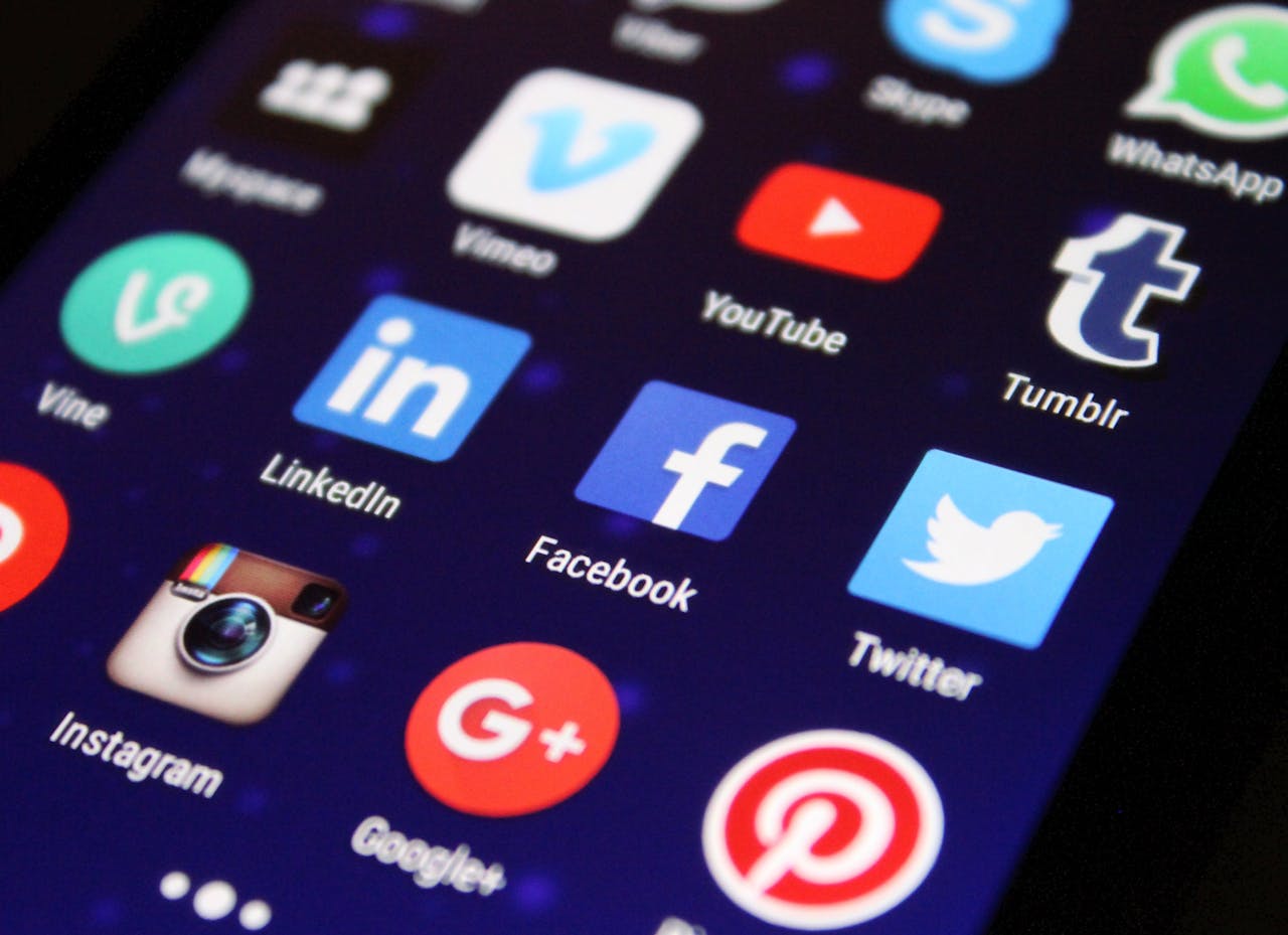 menu-18 Close-up of a smartphone screen showing various social media app icons such as Facebook and Twitter.