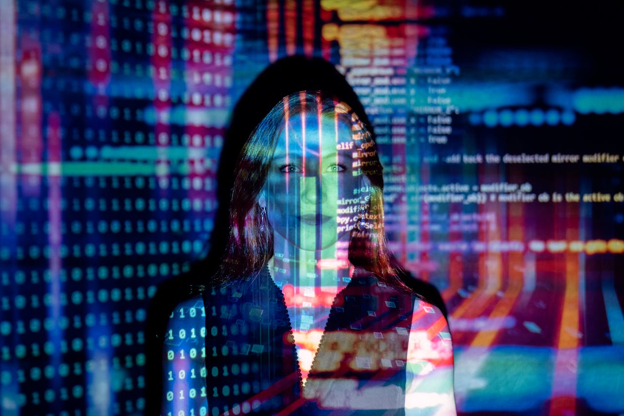 menu-02 A woman with digital code projections on her face, representing technology and future concepts.
