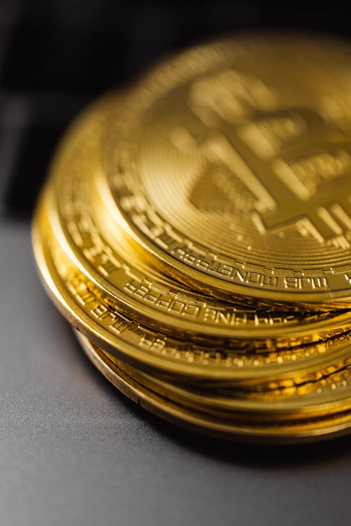 menu-12 Close-up of a stack of shiny gold bitcoins on a computer keyboard, symbolizing digital currency.