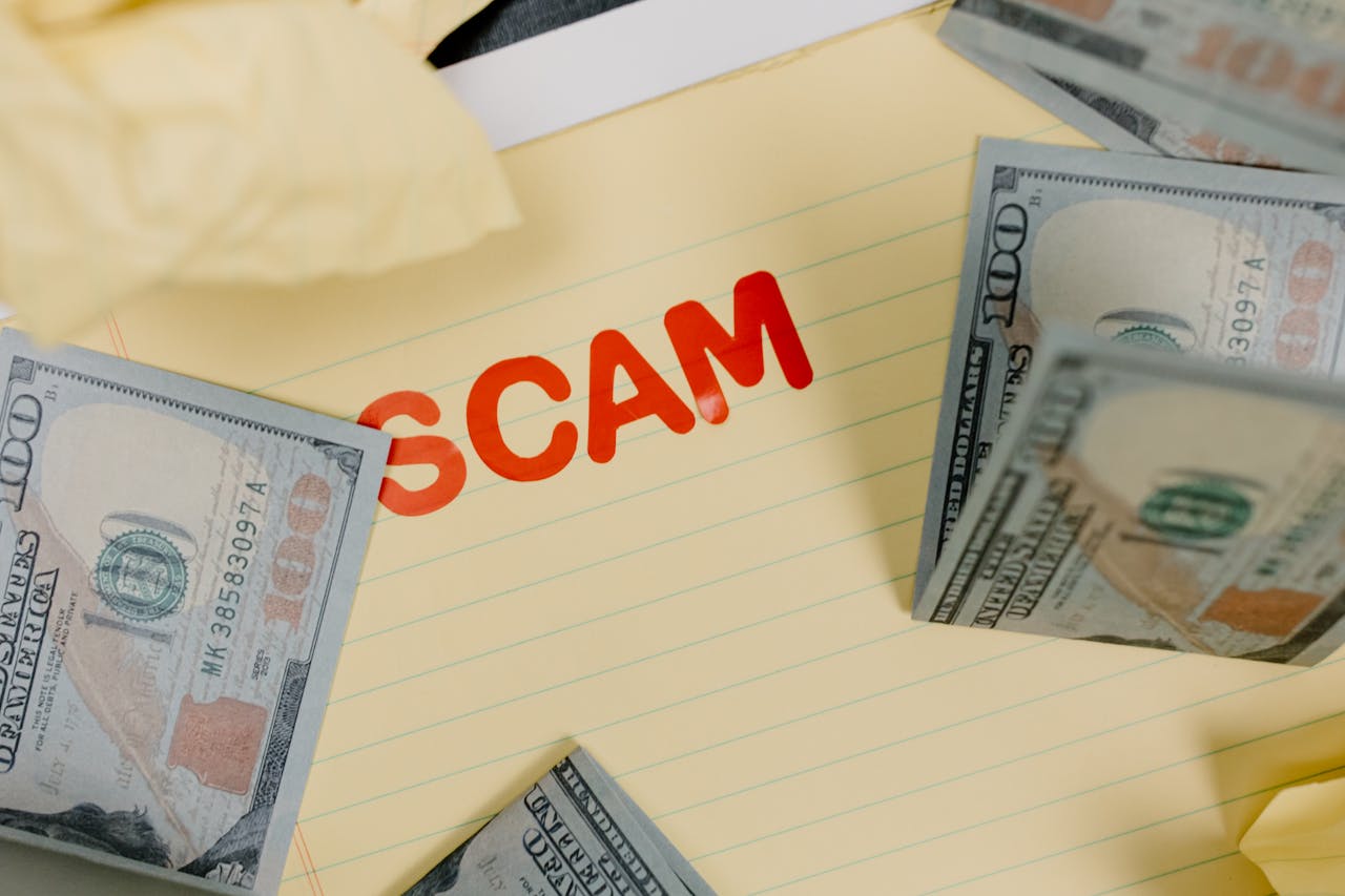 The Art of Drawing Readers In: Your attractive post title goes here Conceptual image of financial scam with US dollars on yellow paper and word 'scam' visible.