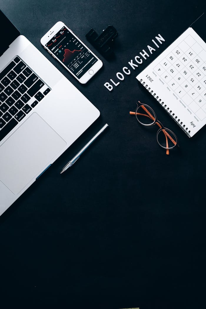 Crafting Captivating Headlines: Your awesome post title goes here Stylish workspace featuring blockchain concept with a laptop and smartphone on a dark background.